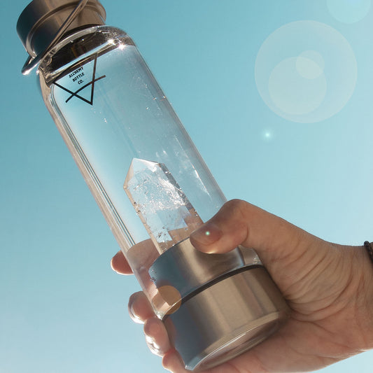 Clear quartz crystal water bottle lifestyle shot — clarity and manifestation healing crystal bottle Australia Alchemy Crystal Co